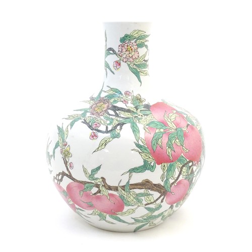 32 - A Chinese famille rose bottle vase decorated in the nine peaches pattern with a fruiting tree with f... 