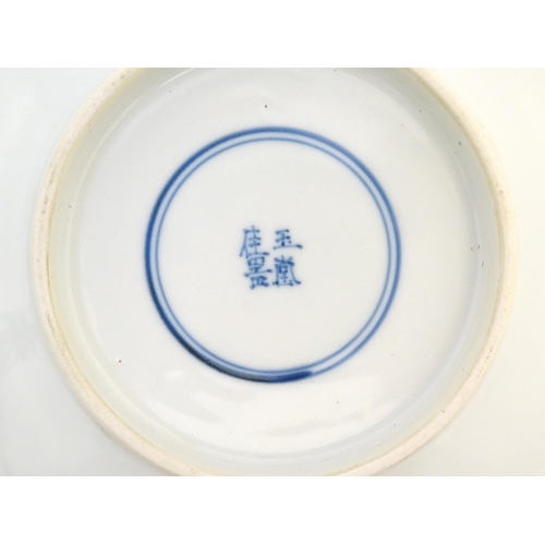 17 - A Chinese blue and white dish decorated with figures in a garden landscape. Character marks under. A... 