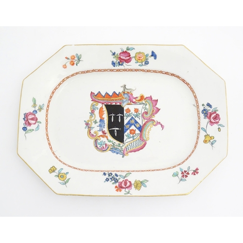 47 - A Chinese export style serving plate with hand painted armorial detail, depicting a coat of arms wit... 