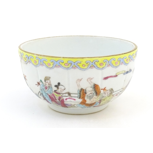 6 - A Chinese famille rose bowl decorated with figures in a stylised landscape. Approx. 3