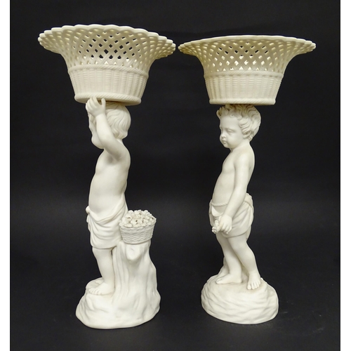 62 - Two Copeland parian ware / bisque centrepieces modelled as a putti supporting a reticulated basket. ... 