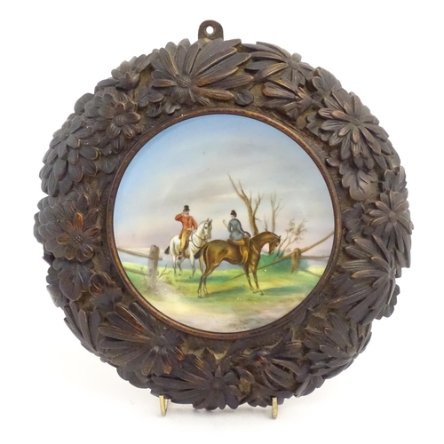 862 - A 20thC dish / plate with hand painted decoration depicting a hunt scene with two figures on horseba... 