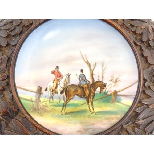 862 - A 20thC dish / plate with hand painted decoration depicting a hunt scene with two figures on horseba... 