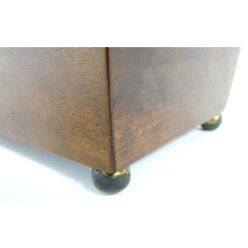 899 - A 19thC walnut tea caddy with crossbanding, opening to reveal two hinge lidded sections within. Toge... 