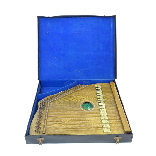 894 - Musical Instrument: a mid 20thC cased zither / autoharp, bearing interior label: 'Supertone Stringed... 