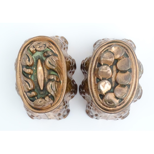 900A - Two Victorian copper jelly moulds, the sides with reeded columns and floral decoration surmounted by... 