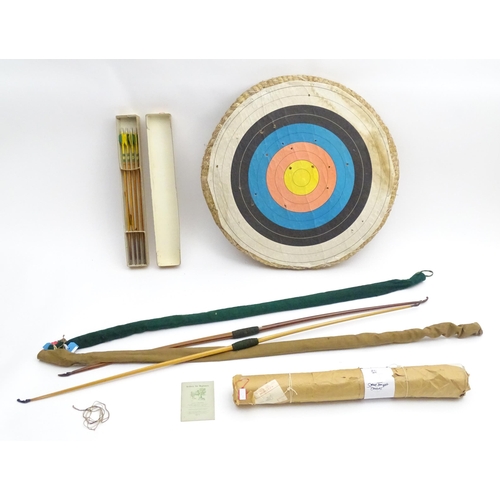 878 - Mid 20thC Archery items, comprising two wooden bows with cloth cases, one marked F H Ayres, London -... 