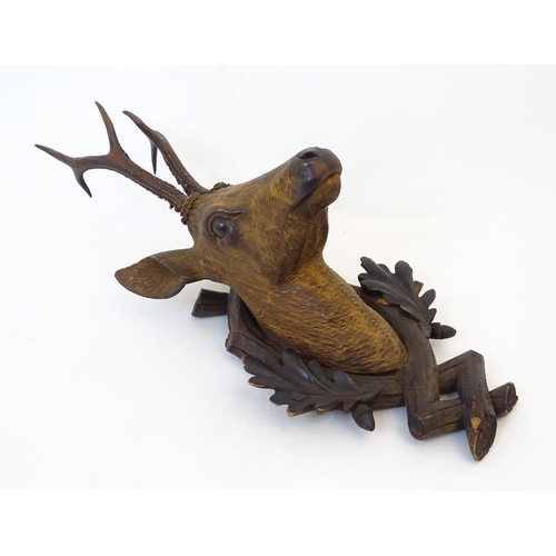 884 - A 19thC Continental Black Forest carved wooden Roe Buck head. Approx. 24 1/2