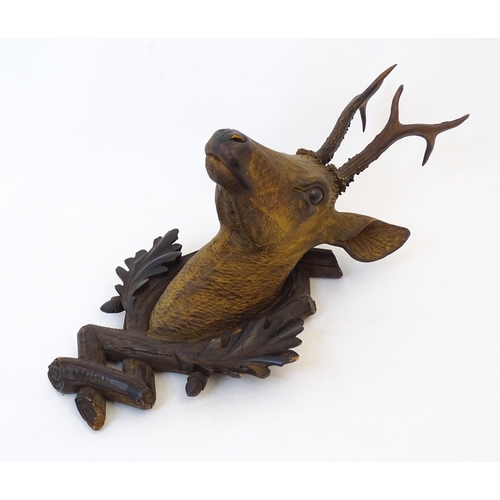 884 - A 19thC Continental Black Forest carved wooden Roe Buck head. Approx. 24 1/2