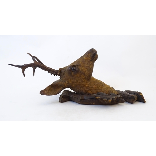 884 - A 19thC Continental Black Forest carved wooden Roe Buck head. Approx. 24 1/2