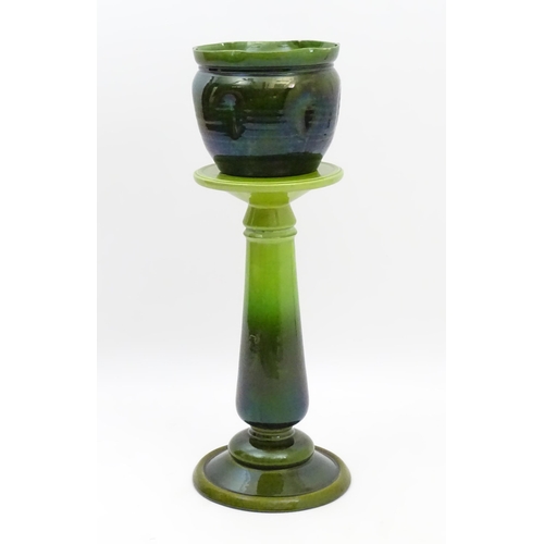 182 - A late 19th / early 20thC Bretby jardiniere / planter on stand with a green glaze. Stand stamped 143... 