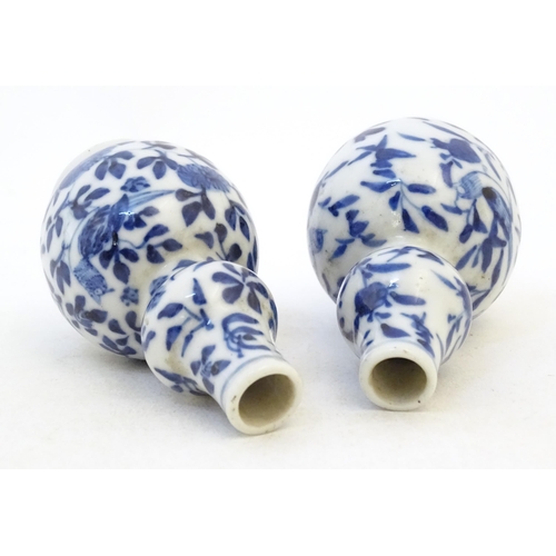 48 - A pair of small Chinese blue and white double gourd vases decorated with birds, flowers and foliage.... 