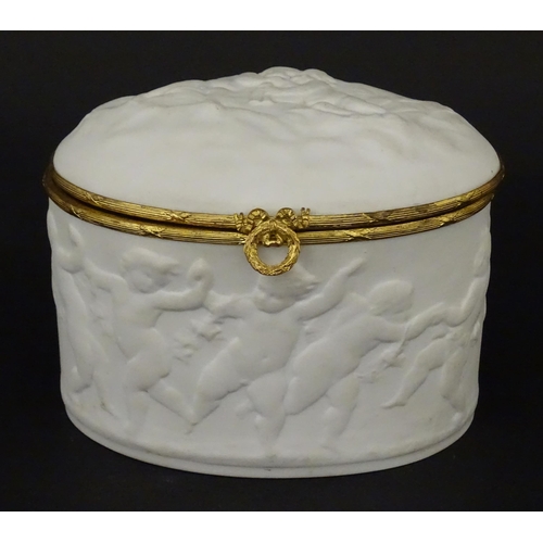 81 - A Limoges parian ware oval box with a hinged lid, decorated in relief with dancing putti / cherubs. ... 