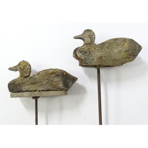 864 - A pair late 19th / early 20thC naive / primitive hand carved wooden Fenland decoy ducks, mounted on ... 