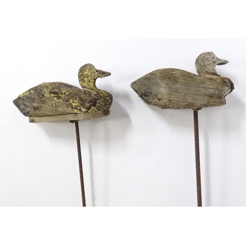 864 - A pair late 19th / early 20thC naive / primitive hand carved wooden Fenland decoy ducks, mounted on ... 