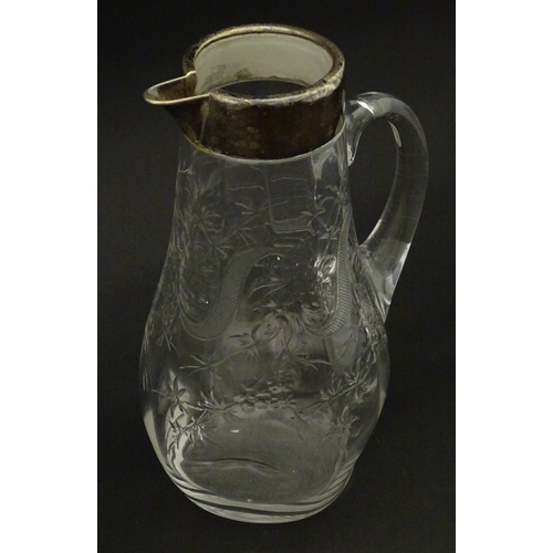 201 - A glass jug / pitcher with floral decoration and silver rim hallmarked London 1892 retailer Asprey. ... 