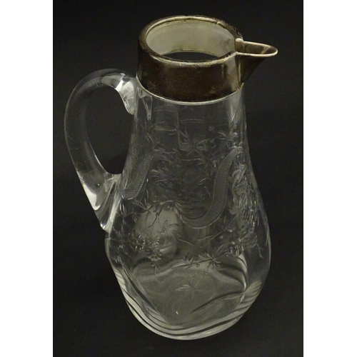 201 - A glass jug / pitcher with floral decoration and silver rim hallmarked London 1892 retailer Asprey. ... 