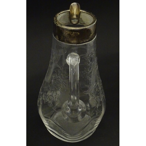 201 - A glass jug / pitcher with floral decoration and silver rim hallmarked London 1892 retailer Asprey. ... 