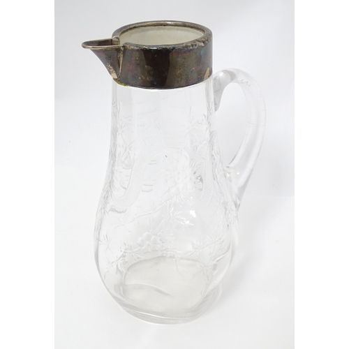 201 - A glass jug / pitcher with floral decoration and silver rim hallmarked London 1892 retailer Asprey. ... 