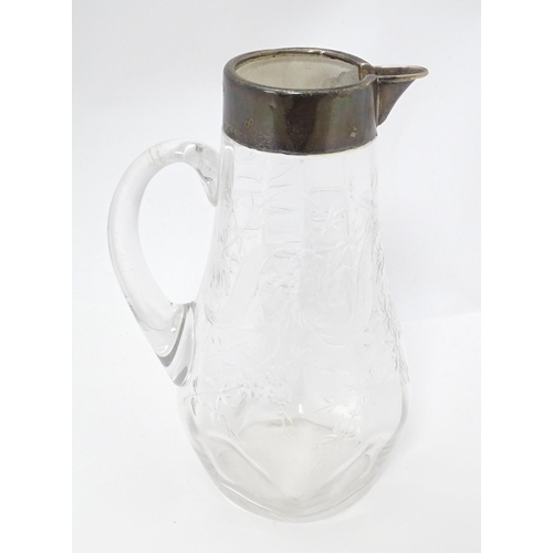 201 - A glass jug / pitcher with floral decoration and silver rim hallmarked London 1892 retailer Asprey. ... 