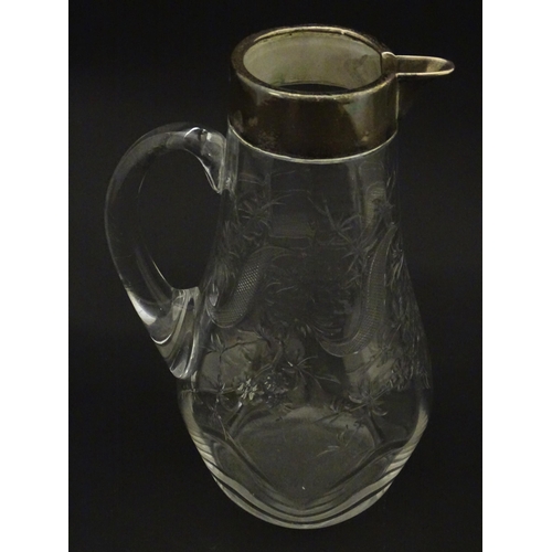 201 - A glass jug / pitcher with floral decoration and silver rim hallmarked London 1892 retailer Asprey. ... 