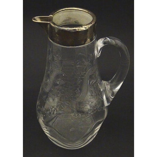 201 - A glass jug / pitcher with floral decoration and silver rim hallmarked London 1892 retailer Asprey. ... 