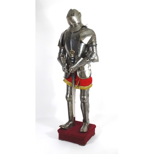 1817 - Militaria: a 20thC medieval style suit of armour, constructed from articulated steel panels and moun... 