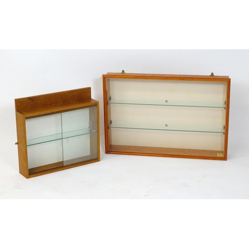 6 - Two glass display cabinets. Largest approx. 33