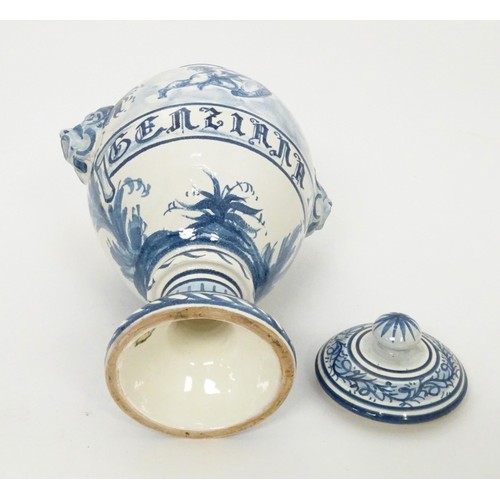 11 - A Continental blue and white faience style pedestal vase and cover with twin mask handles, the body ... 