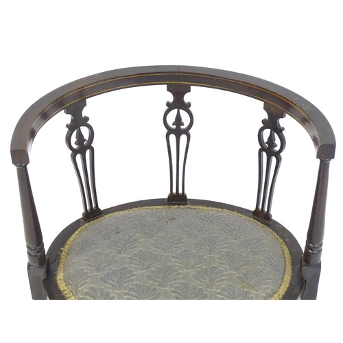 18 - An Edwardian tub chair with three pierced back splats above an oval seat and four turned tapering le... 