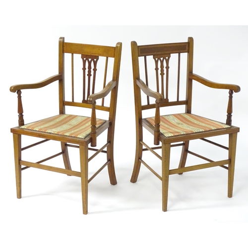 27 - A pair of early 20thC mahogany elbow chairs with satinwood cross banded frames and pierced back spla... 