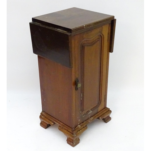 62 - A mahogany bedside / pot cupboard with drop flap top. Approx. 31 1/2