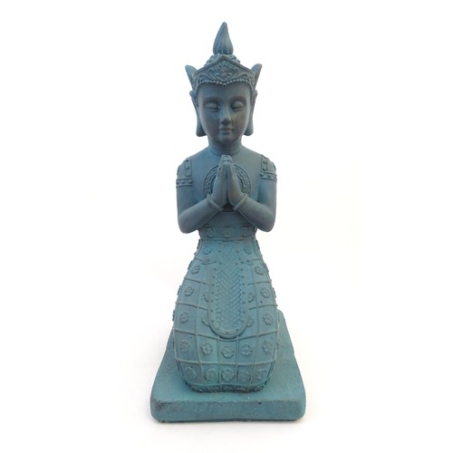 65 - A cast composite model of a kneeling Buddha. Approx. 25