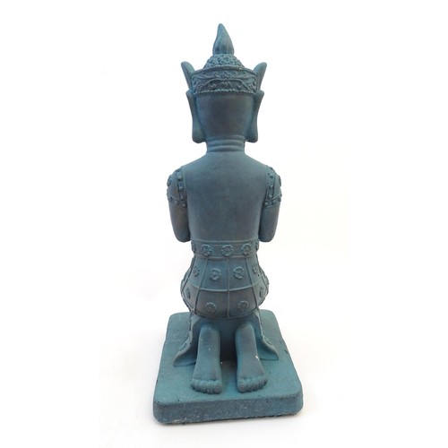 65 - A cast composite model of a kneeling Buddha. Approx. 25