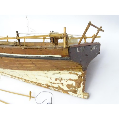 69 - A model of a sail boat, the hull titled Love and Peace. Approx 48