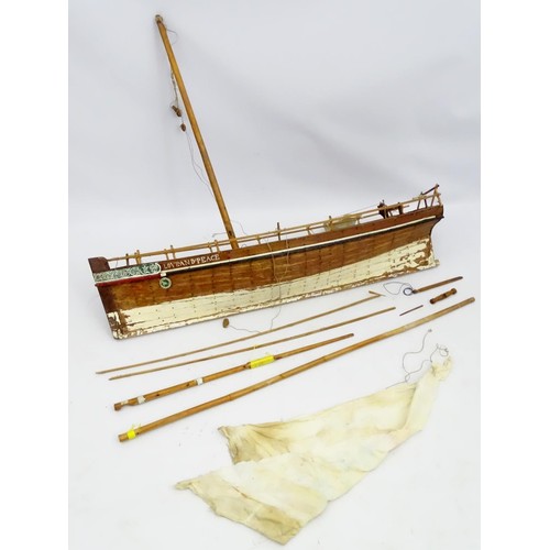 69 - A model of a sail boat, the hull titled Love and Peace. Approx 48