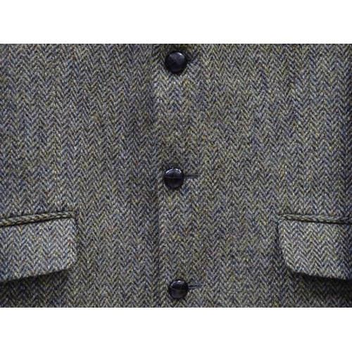 51 - A Harris Tweed hacking jacket by Gurtex, with three buttons to front and single vent to rear, measur... 