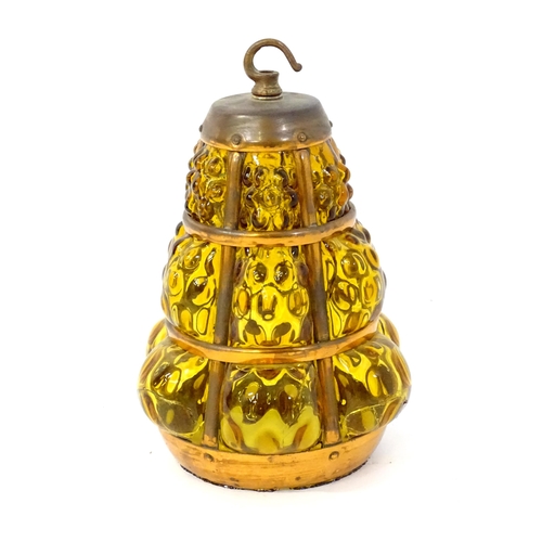 43 - An Arts and Crafts style pendant shade with amber glass panels and copper banding. Approx 10 1/2