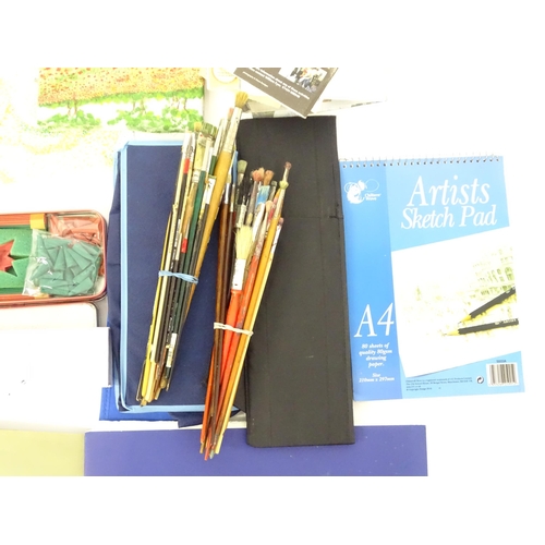16 - A quantity of artist materials to include brushes, paper, paints, Chinese artist materials, canvases... 