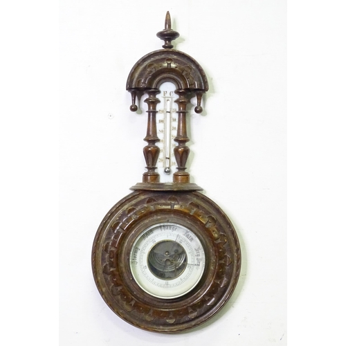 71 - An aneroid barometer / thermometer within a carved wooden surround. Approx 16