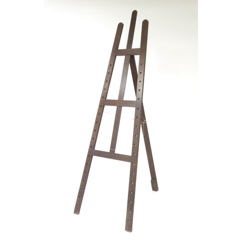 104 - An adjustable artist's easel, marked Newman.