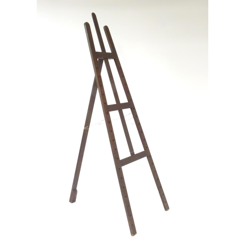 104 - An adjustable artist's easel, marked Newman.