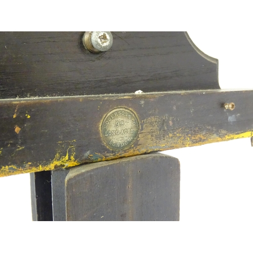 106 - An adjustable artist's easel, marked Roberson & Co. 99 Longacre, London.