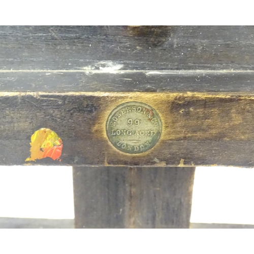 106 - An adjustable artist's easel, marked Roberson & Co. 99 Longacre, London.