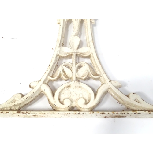 48 - A pair of cast and white painted table support with floral and thistle detail, bearing marks for H. ... 