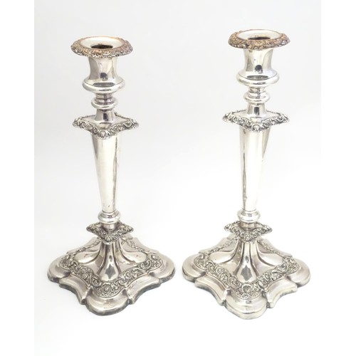 942 - A pair of silver plate candlesticks with acanthus scroll and floral decoration Approx 12