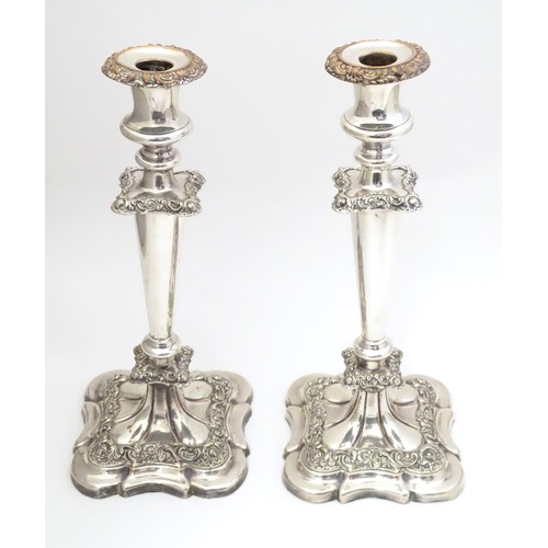 942 - A pair of silver plate candlesticks with acanthus scroll and floral decoration Approx 12