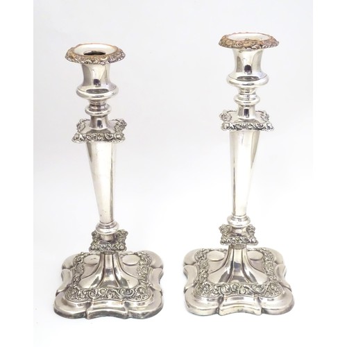 942 - A pair of silver plate candlesticks with acanthus scroll and floral decoration Approx 12