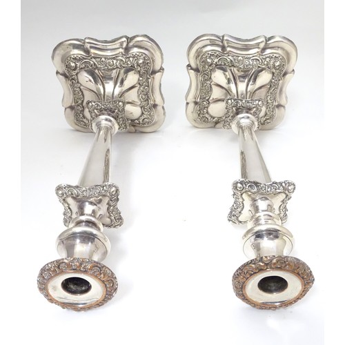 942 - A pair of silver plate candlesticks with acanthus scroll and floral decoration Approx 12