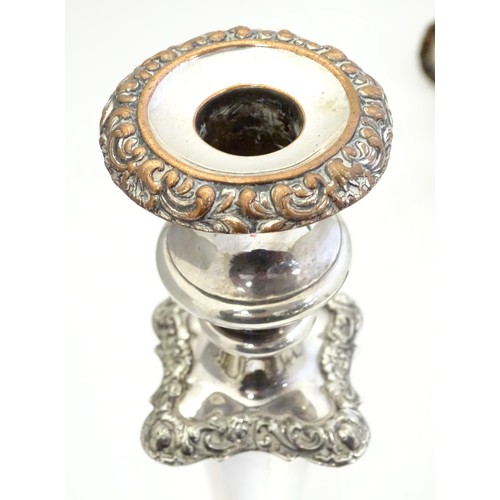 942 - A pair of silver plate candlesticks with acanthus scroll and floral decoration Approx 12